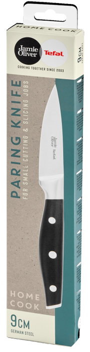 Schräg von vorn fotografierte Verpackung eines Jamie Oliver x Tefal Home Cook Gemüsemessers (Paring Knife) mit schwarzem Griff, 9 cm Klinge aus deutschem Stahl