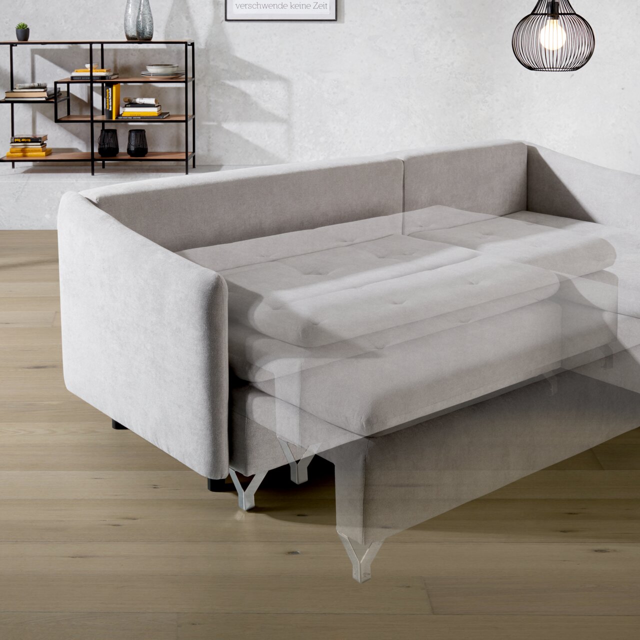 Graue Rundecke mit ausziehbarer Schlafmöglichkeit, seitliche Perspektive