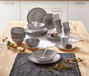 Kombiservice Tokyo 30-tlg. in einer modernen Küche, von oben fotografiert. Das Set besteht aus Tellern, Schalen und Tassen mit schwarzem geometrischem Muster.