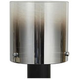 Moderne Tischleuchte mit zylindrischem, rauchgrauem Glasschirm, frontal betrachtet.