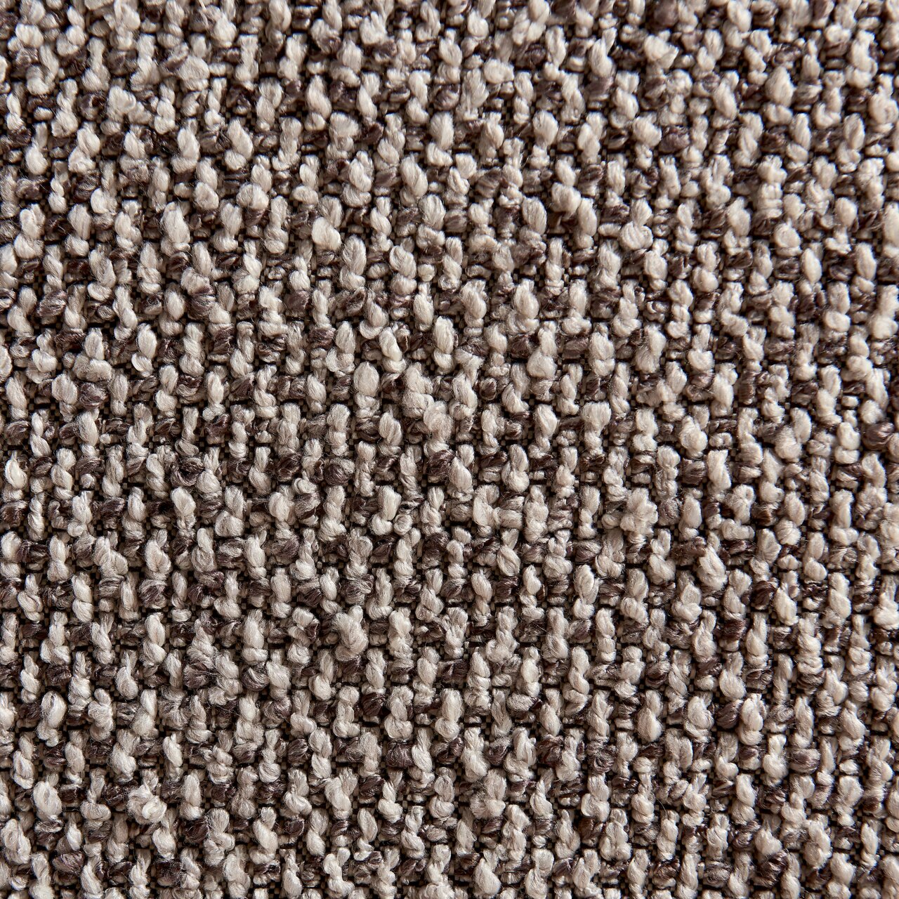Close-up van een gestructureerde, grijze stof die wordt gebruikt voor een fauteuil, gezien van bovenaf.