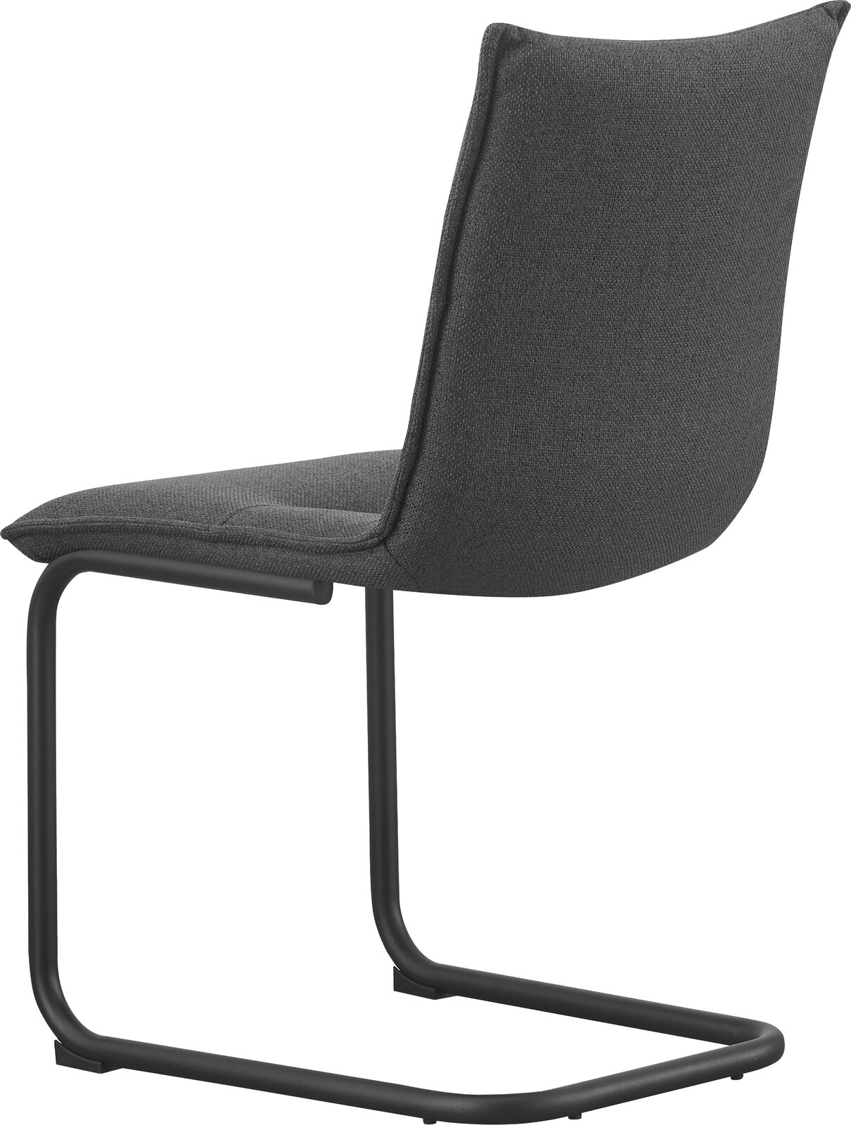 Dunkelgrauer Polsterstuhl mit Stoffbezug und schwarzem Freischwinger-Metallgestell, seitliche Ansicht leicht von hinten vor weißem Hintergrund.