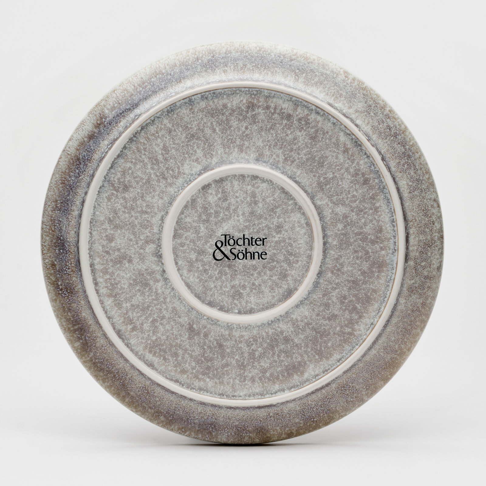 Rückansicht eines Tellers mit grauem, gesprenkeltem Design und dem Logo 'Töchter & Söhne' in der Mitte.
