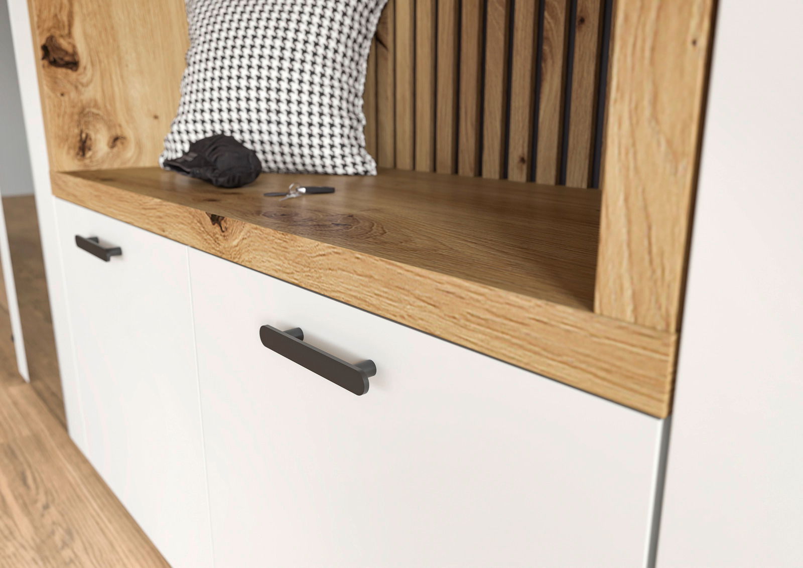 Nahaufnahme einer Kompaktgarderobe mit weißem Schrank, Holzdetails und schwarzen Griffen. Perspektive von schräg oben.