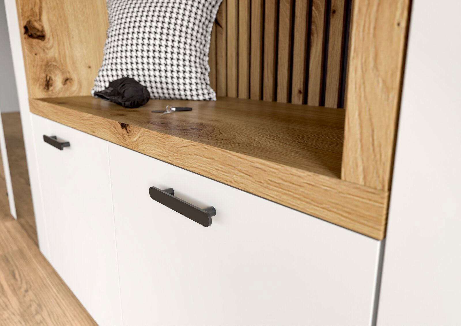 Nahaufnahme einer Kompaktgarderobe mit weißem Schrank, Holzdetails und schwarzen Griffen. Perspektive von schräg oben.