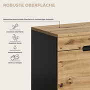 Nahaufnahme eines Möbelstücks in Holzoptik mit schwarzer Seitenfläche; melaminharzbeschichtete, robuste Oberfläche (kratzfest, stoßfeste Kante, wasserabweisend, leicht zu reinigen) – Perspektive: schräg von oben auf die Ecke.