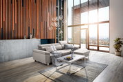 Moderne Rundecke in einem hellen Wohnzimmer mit großen Fenstern, die einen Blick auf die Stadt bieten. Die Perspektive zeigt die Rundecke von vorne, mit einem Couchtisch und Dekorationen im Vordergrund.