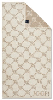 Beige handdoek met geometrisch patroon en JOOP!-logo, van bovenaf gefotografeerd.