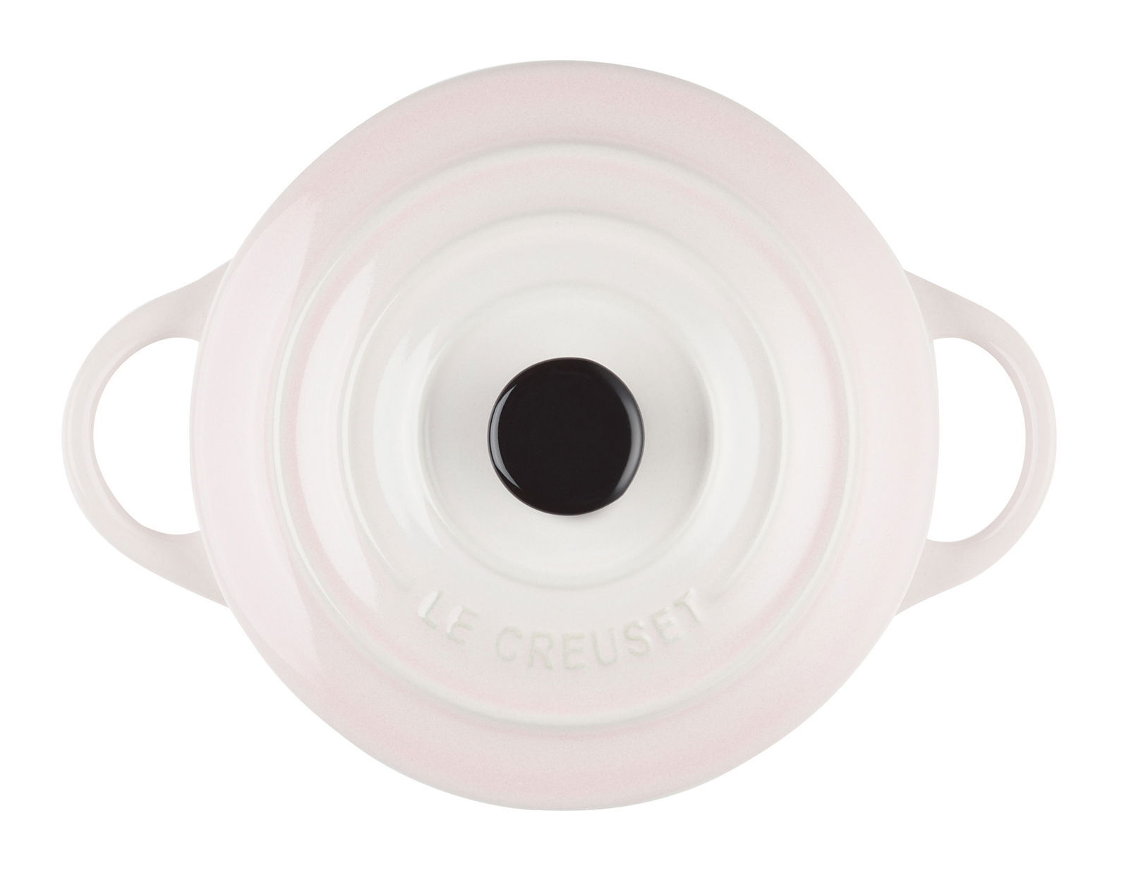 Obenansicht einer Mini-Cocotte in Muschelrosa mit zwei Griffen und einem schwarzen Knauf auf dem Deckel.