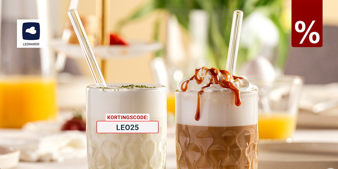 Twee latte-dranken in gestructureerde glazen – matcha latte en caramel latte met slagroom – op een gedekte ontbijttafel met croissant en sinaasappelsap