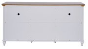 Rückansicht eines weißen Sideboards mit Holzoberfläche und runden Füßen.
