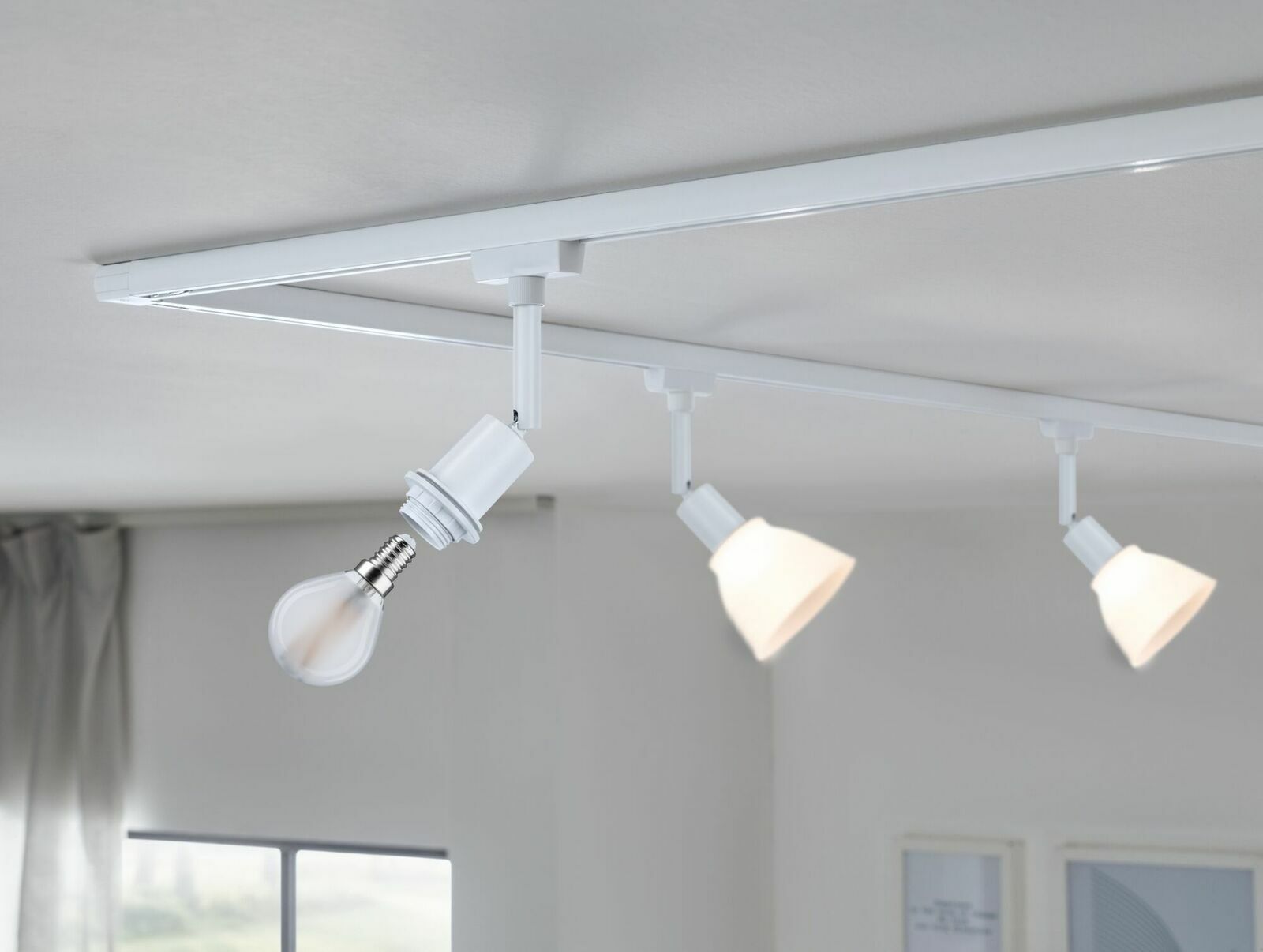 PAULMANN Basisspot URAIL Deckenmontiertes URail Basisspot-System von Paulmann mit drei weißen Spots, seitliche Perspektive.