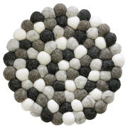 Runder Untersetzer aus Filzkugeln in verschiedenen Grautönen und Weiß, von oben betrachtet.