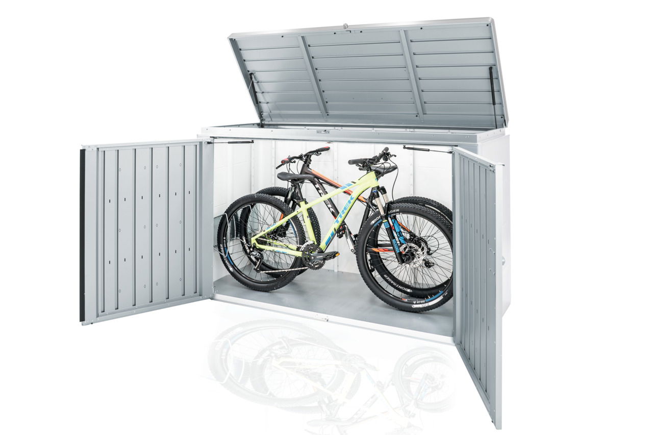 Metallbox mit geöffnetem Deckel und Türen, die zwei Fahrräder von vorne zeigt.