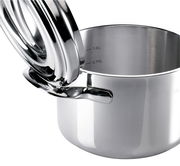 Nahaufnahme eines glänzenden Edelstahltopfs mit geöffnetem Deckel, sichtbare Messskala im Inneren.