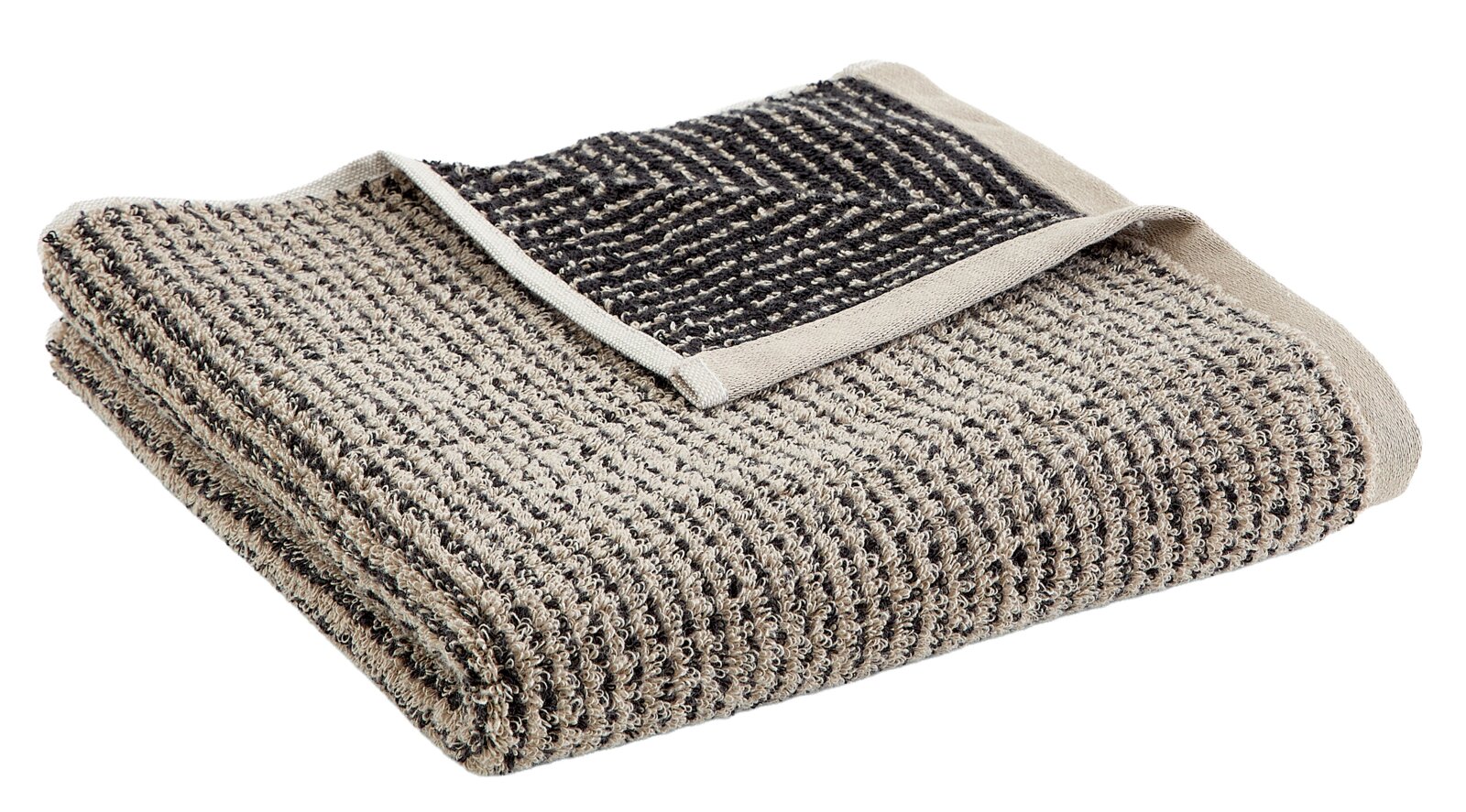Een opgevouwen handdoek in beige en zwart, gezien vanuit vogelperspectief