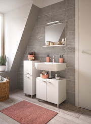 Moderner Badschrank BOSTON in einem stilvollen Badezimmer mit grauen Fliesen und einem Waschbecken, seitliche Perspektive.