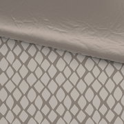 Wendebettwäsche mit geometrischem Muster in Nahaufnahme, eine Seite unifarben, die andere mit Rautenmuster.