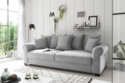 Graues Funktionssofa mit mehreren Kissen in einem modernen Wohnzimmer, seitliche Perspektive.
