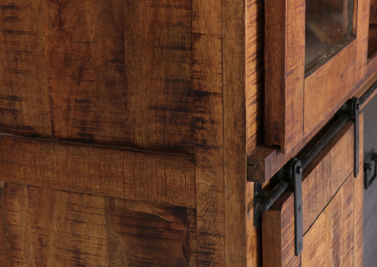 Nahaufnahme einer rustikalen Holztür mit Metallbeschlägen, seitliche Perspektive.