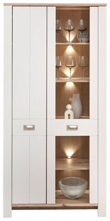 Vitrine mit weißem Rahmen und Holzelementen, beleuchtete Regale mit Gläsern und Dekorationen, Frontalansicht