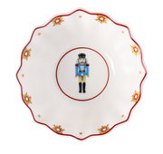 Porzellanschale mit Nussknacker-Motiv und goldenen Sternen, von oben betrachtet.