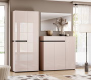 Frontansicht eines modernen, hochglänzenden Flurmöbel-Sets in Rosé/Beige mit hohem Schrank und Sideboard, darüber ein Wandspiegel, dekoriert mit Vase und Trockenblumen in einem hellen Wohnraum