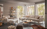Ecksofa DETROIT von Musterring in einem modernen Wohnzimmer mit großen Fenstern, aus der Perspektive von vorne links betrachtet.