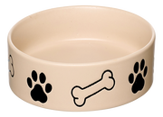 Beige Hundenapf mit schwarzen Pfotenabdrücken und Knochenmotiven, seitliche Perspektive