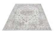 Teppich mit floralem Muster in Beige- und Grautönen, Perspektive von schräg oben