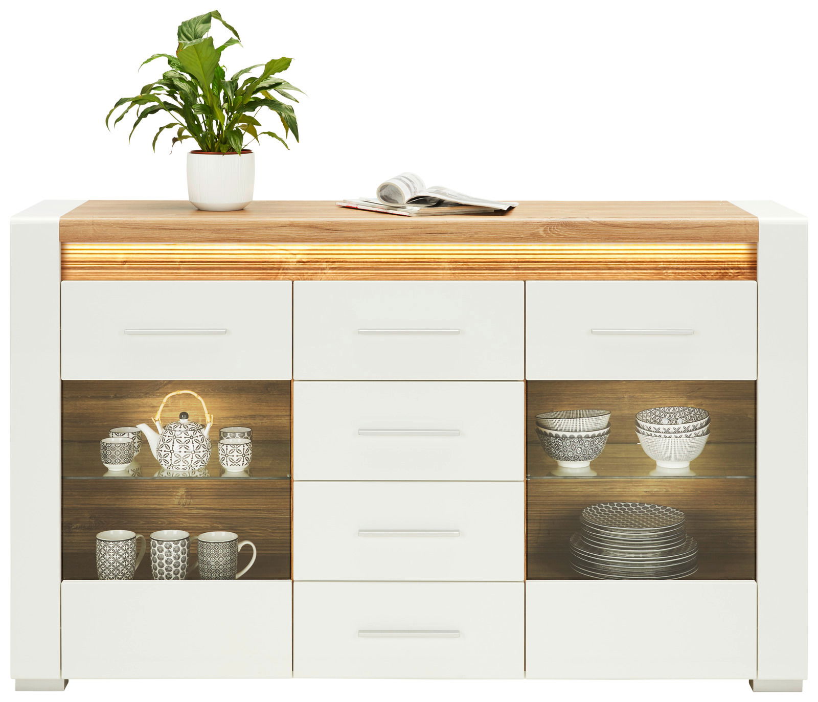 Modernes Sideboard mit weißem und holzfarbenem Design, dekoriert mit einer Pflanze und einem Buch auf der Oberseite, frontal betrachtet.