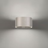 Moderne Wandleuchte PURE Clipse in zylindrischer Form aus gebürstetem Metall, Ansicht von vorne.