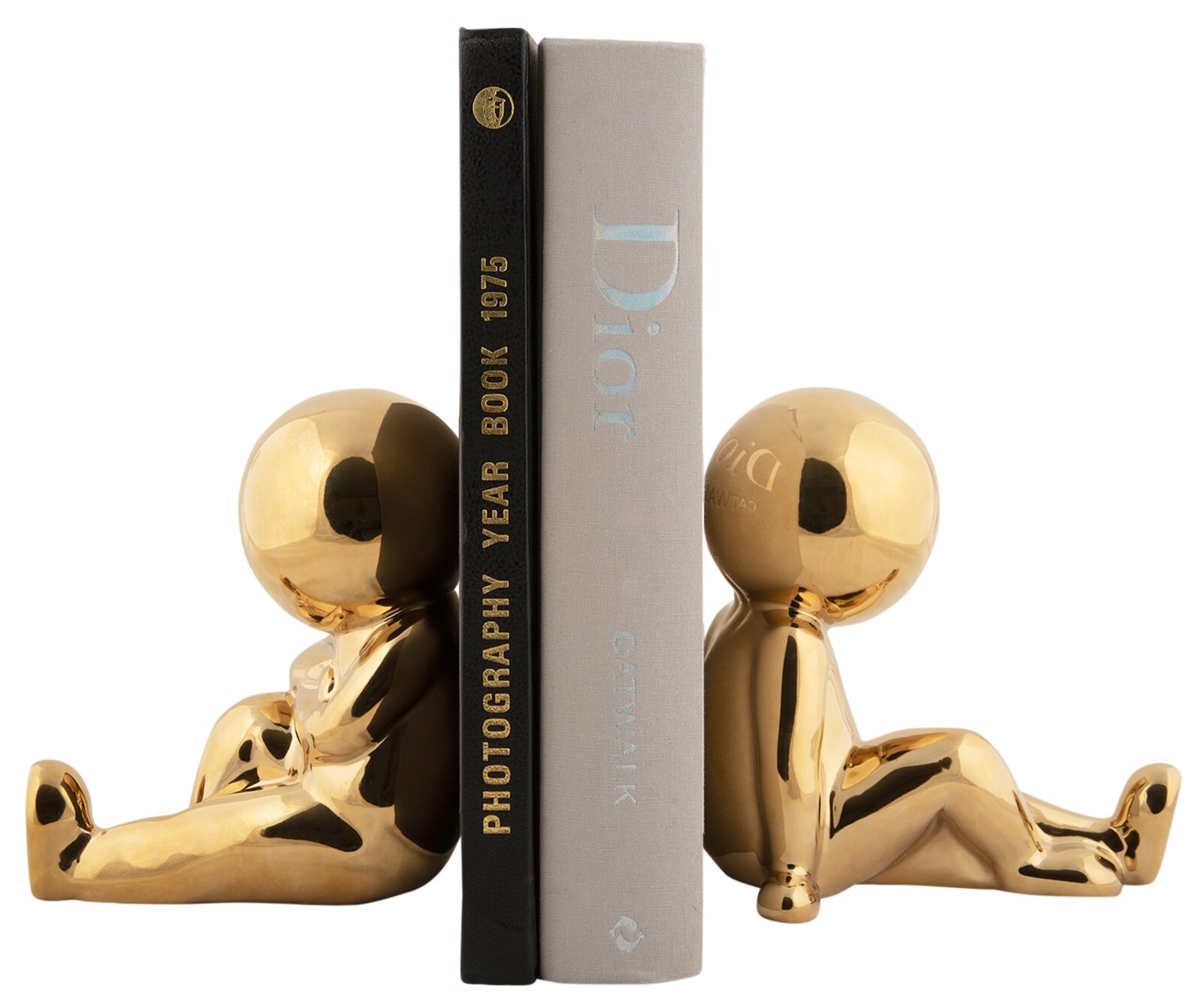 Twee gouden boekensteunen in de vorm van zittende figuren die boeken rechtop houden. Aanzicht vanaf de zijkant.
