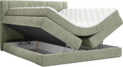 Groen gestoffeerd boxspringbed met gewatteerd hoofdbord en wit matras, opbergfunctie geopend met omhooggeklapt liggedeelte; perspectief: schuin van voren (3/4-aanzicht).