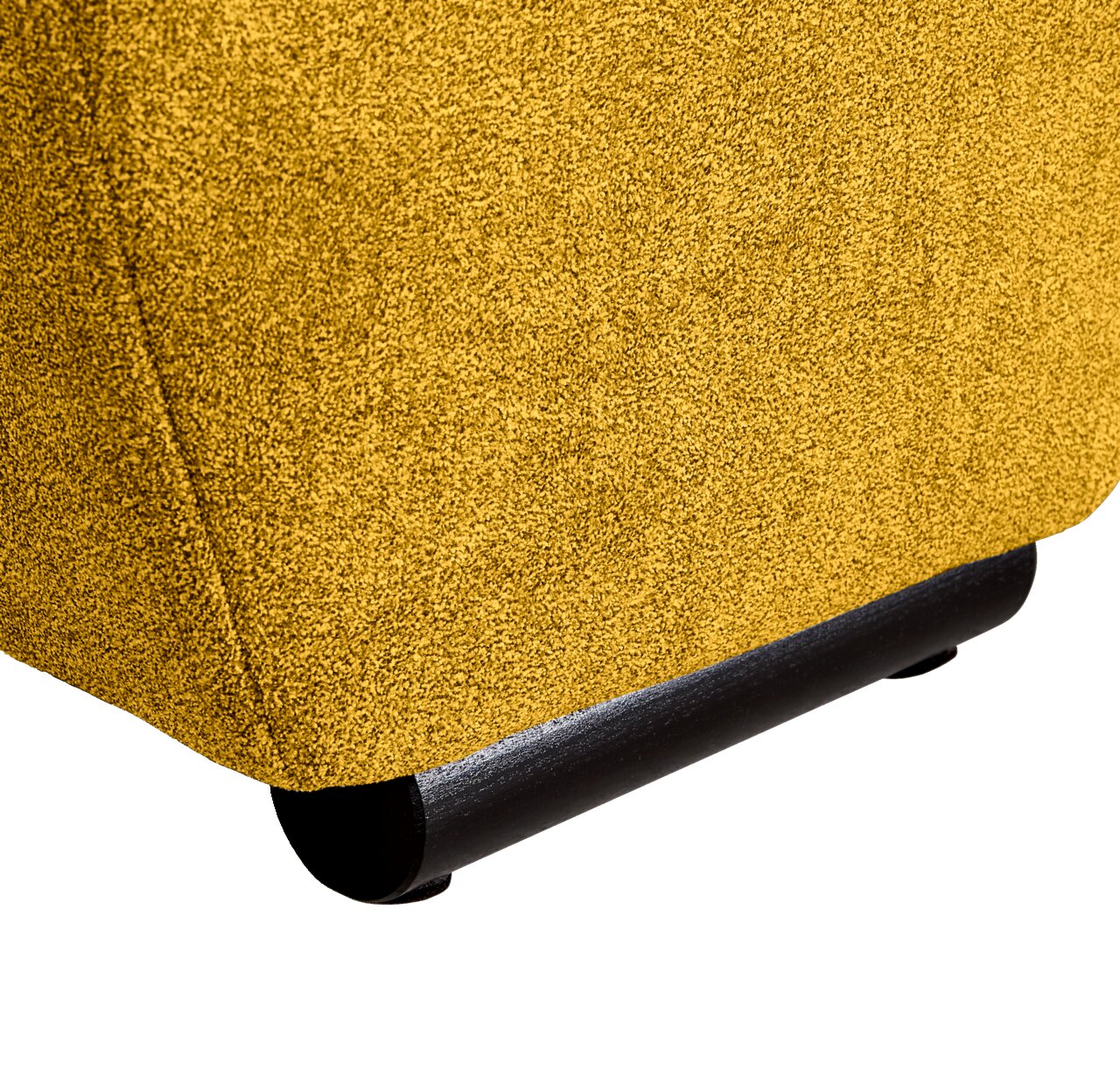 Nahaufnahme der unteren Ecke eines gelben Big-Sofas mit schwarzem Fuß, seitliche Perspektive.