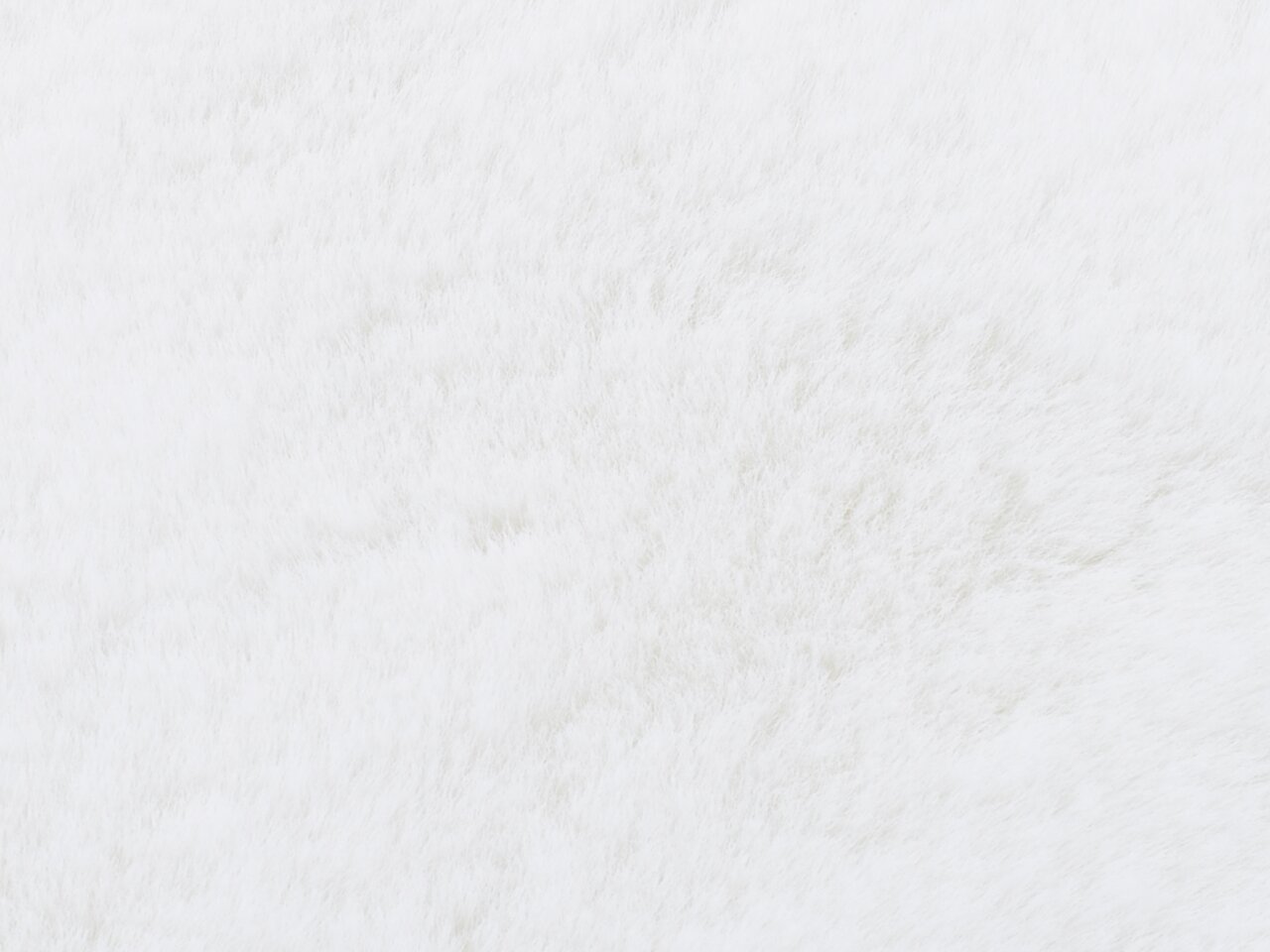 Nahaufnahme eines weißen Fellteppichs aus der Vogelperspektive