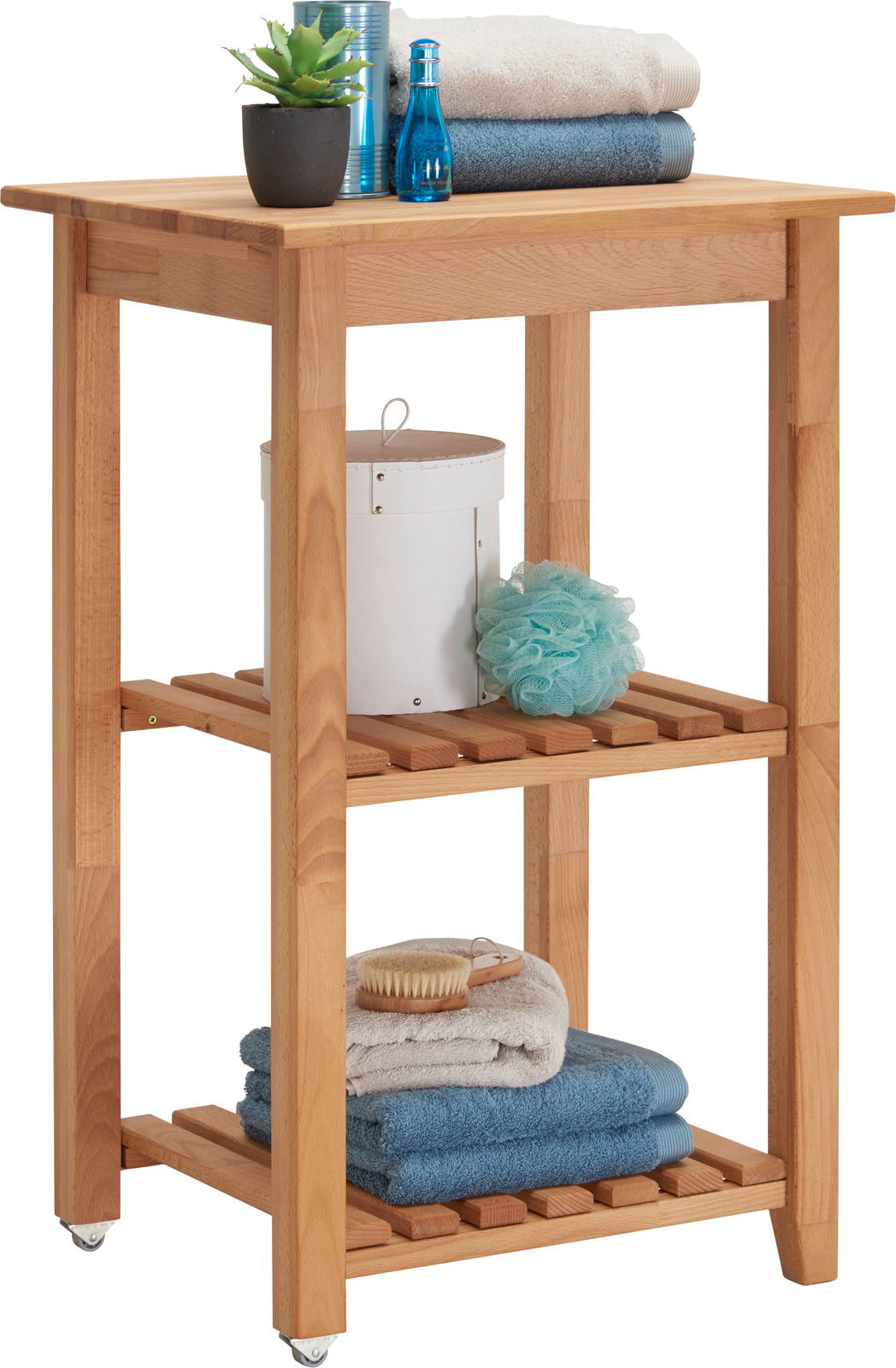 Holz-Servierwagen mit zwei Regalböden, dekoriert mit Handtüchern, Pflanzen und Pflegeartikeln, seitliche Perspektive