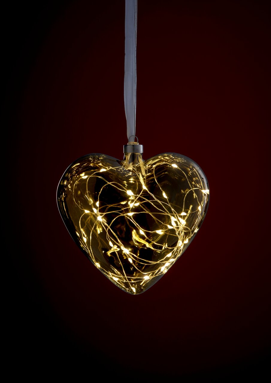 LED-Glasherz mit warmweißen Lichtern, hängend vor einem dunklen Hintergrund, frontal betrachtet.