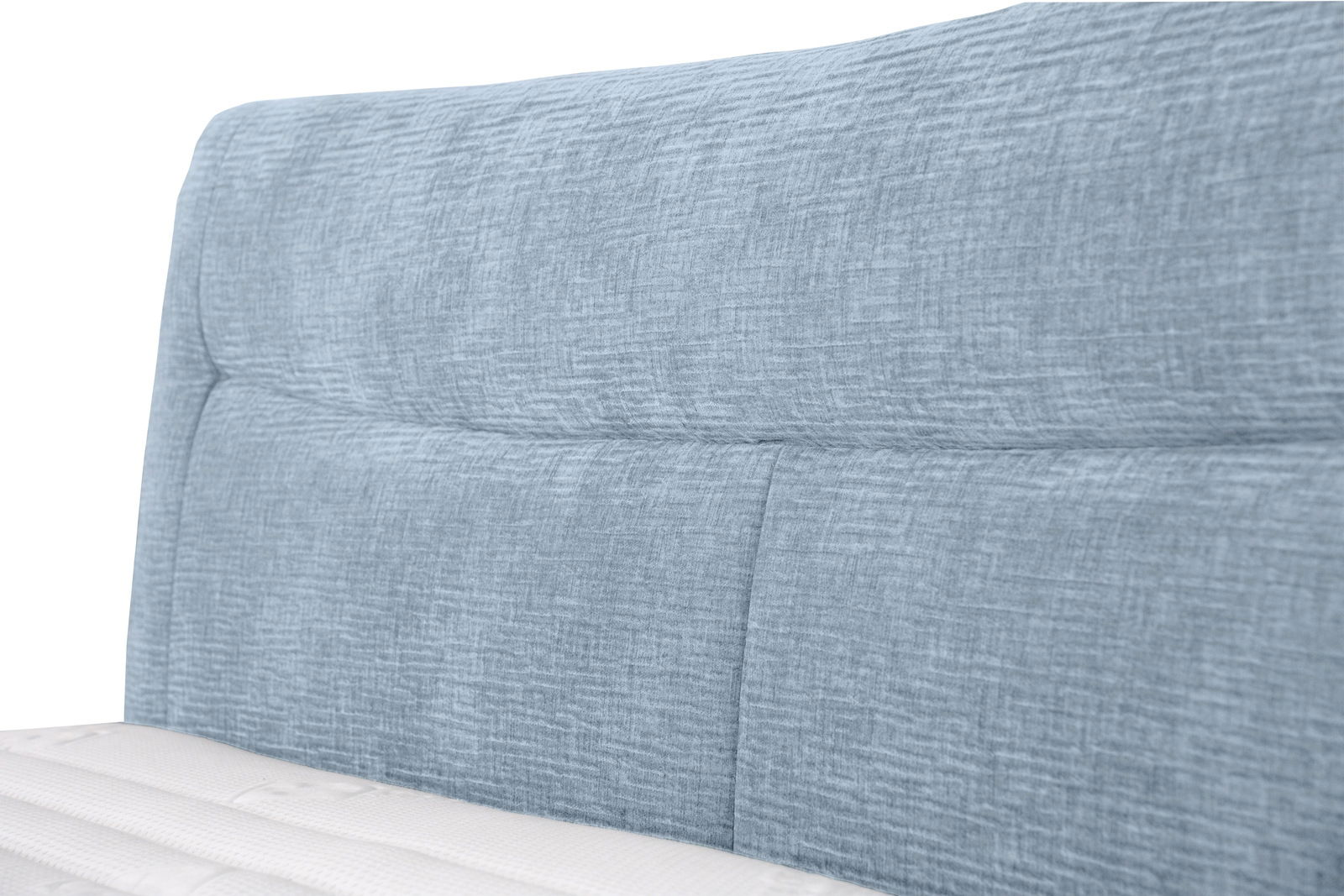 Nahaufnahme eines blauen Boxspringbett-Kopfteil mit strukturierter Oberfläche, seitliche Perspektive