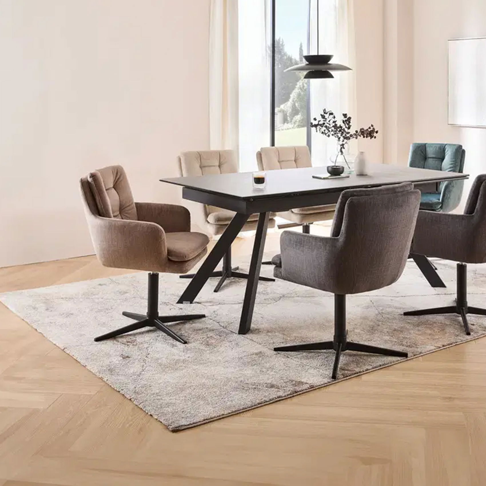 Moderner Essbereich mit Polsterstühlen in Beige und Grau um einen schwarzen Tisch auf hellem Teppich