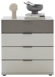 Schubkastenkommode mit vier Schubladen, obere Schublade mit wellenförmiger Struktur, dekoriert mit einer Skulptur, Büchern und einer Schale, Frontalansicht.