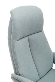 Nahaufnahme eines hellgrauen Relaxsessels mit weicher Polsterung, seitliche Perspektive