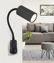 Moderne schwarze Wandleuchte mit flexiblem Arm, seitliche Perspektive, in einem stilvollen Wohnzimmer montiert.