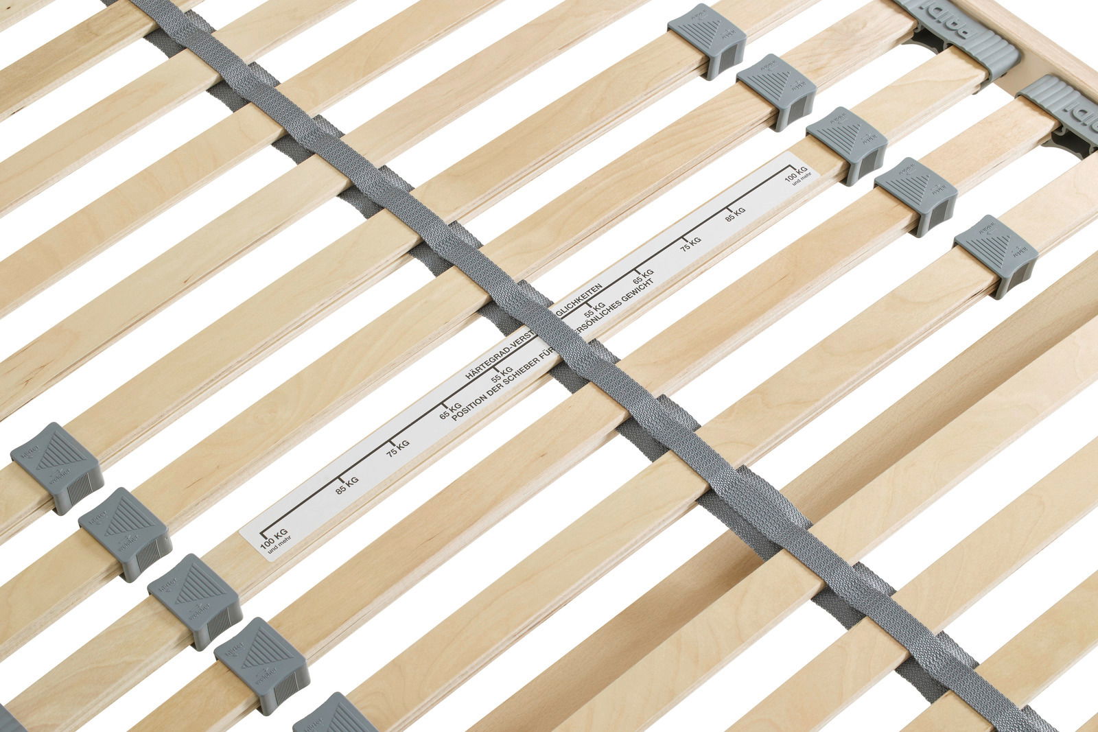 Nahaufnahme eines Federholzrahmens mit verstellbaren Schiebern und Gewichtsmarkierungen, von oben betrachtet.