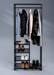 Schwarzer Garderobenwagen mit mehreren Kleiderstangen und Regalböden, frontal fotografiert, mit verschiedenen Kleidungsstücken und Schuhen.