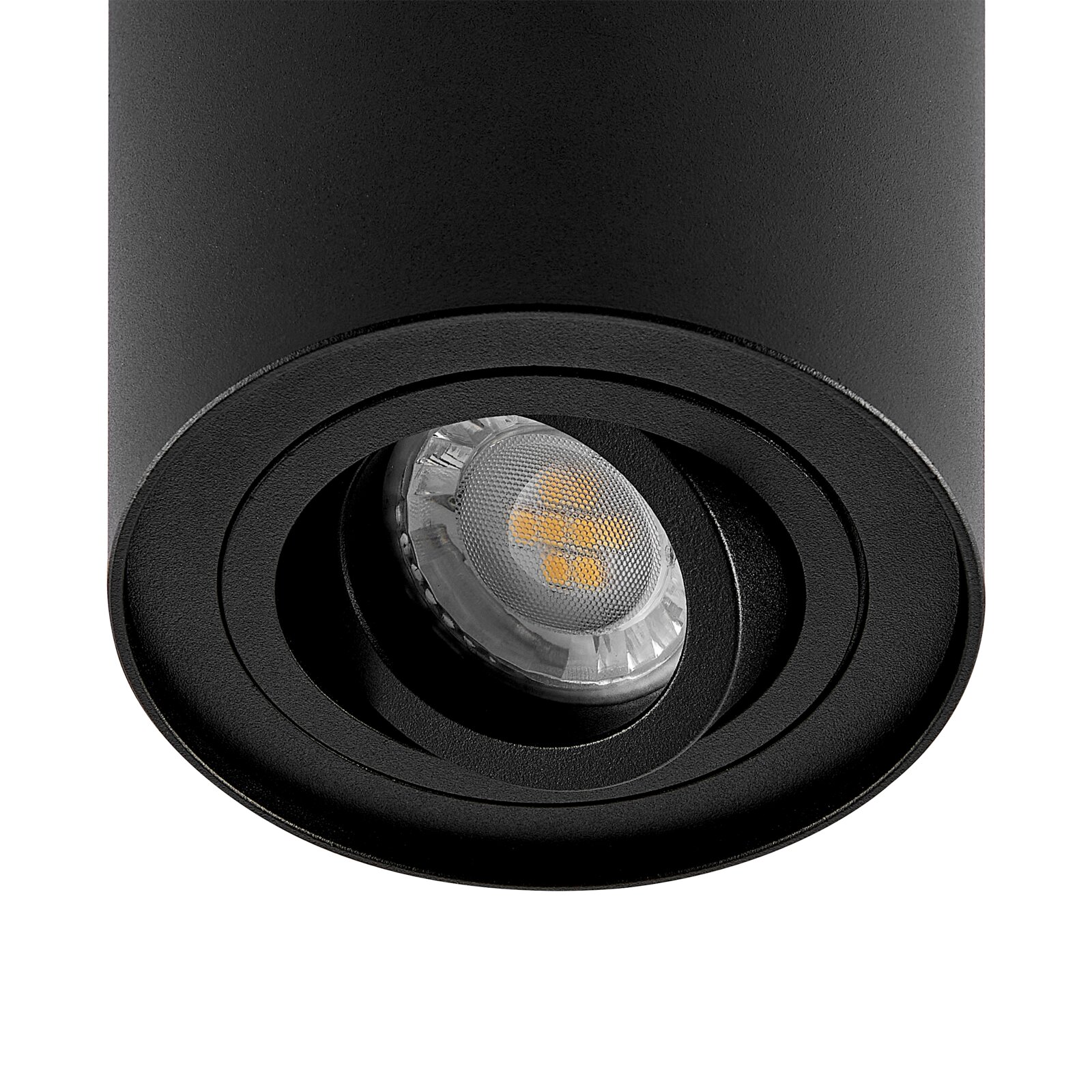 Close-up van een zwarte cilindrische straler met zichtbare ledlamp, gezien van onderaf.
