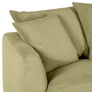 Groene hoekbank met geribbelde stoffen bekleding, close-up vanaf de zijkant