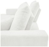 Nahaufnahme einer weißen, gerippten Sofaecke mit zwei großen Kissen, seitliche Perspektive.