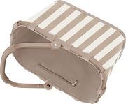 Beige-weiß gestreifte, faltbare Aufbewahrungsbox mit Reißverschlussfach und Tragegriff, schräg von oben in Seitenansicht fotografiert.