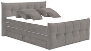 Graues Boxspringbett mit gepolstertem Kopf- und Fußteil, seitliche Perspektive